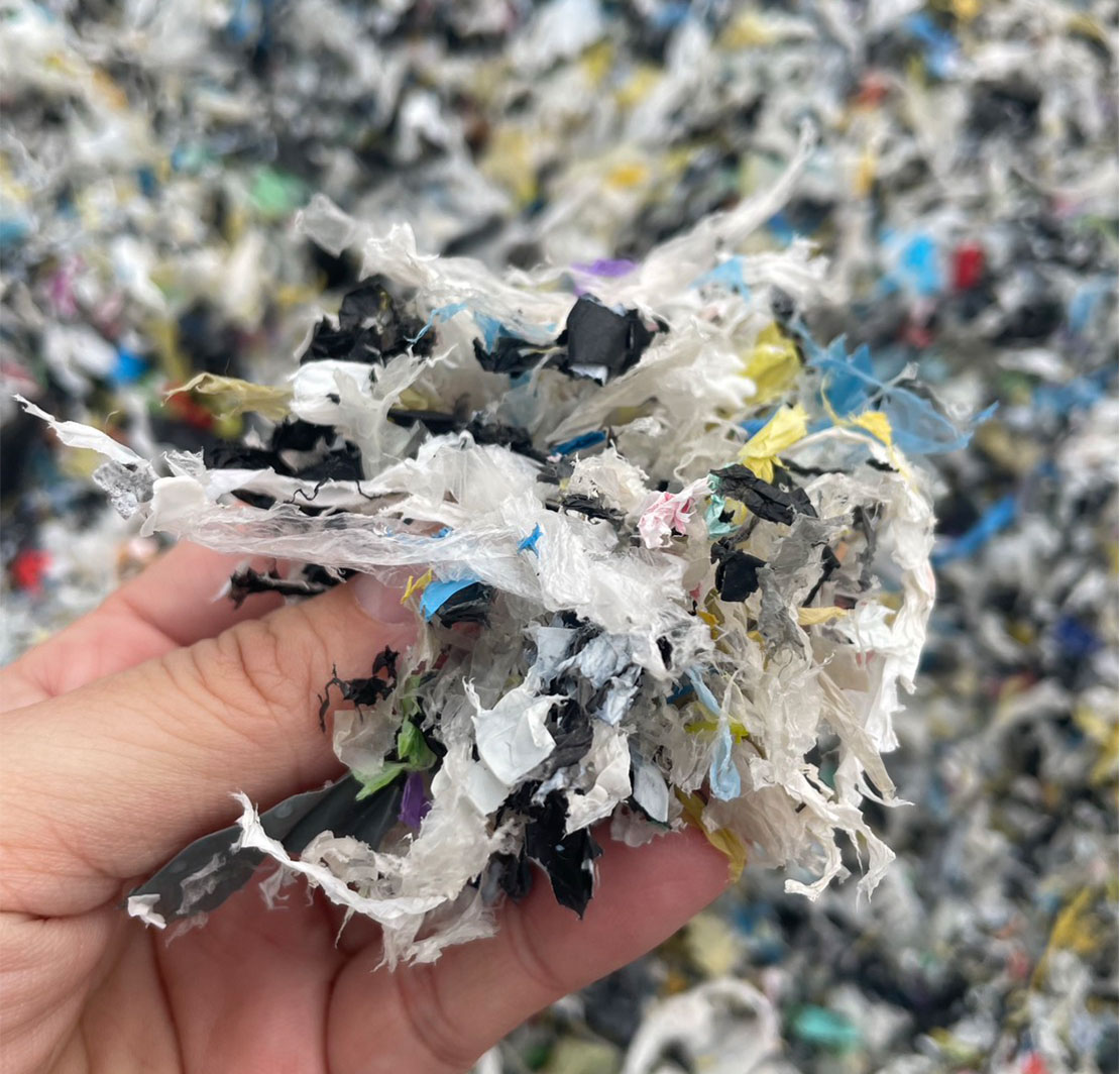 A close-up of typical washing line rejects—a heavy, wet mix of film and pulp that retains water like a sponge, driving up disposal fees.